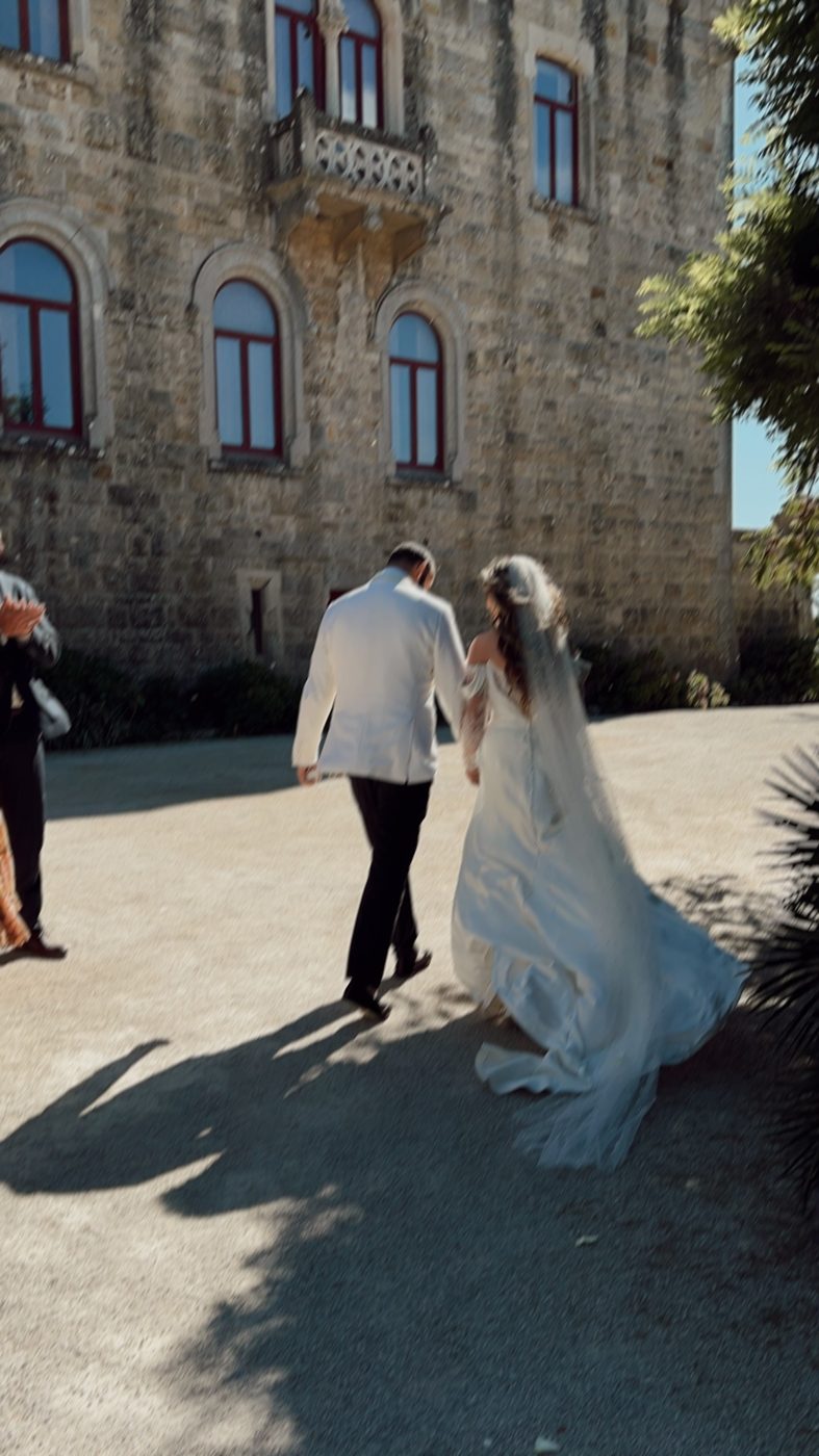 A wedding couple walking through a historic setting